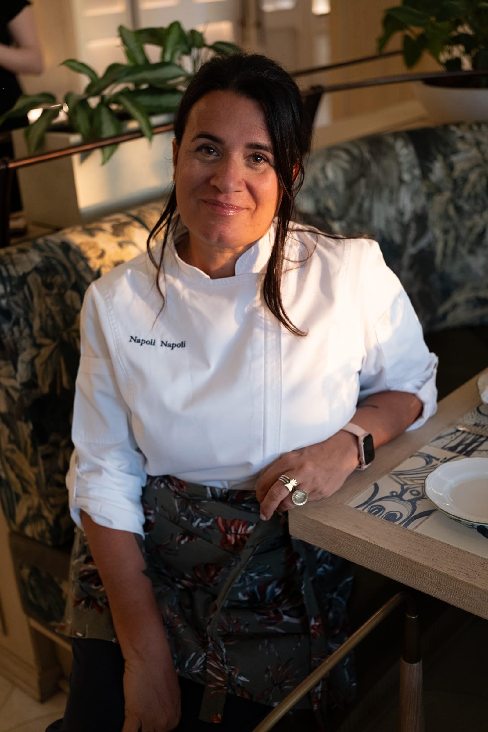 Giordana at a laid table, in her Napoli Napoli chef's jacket