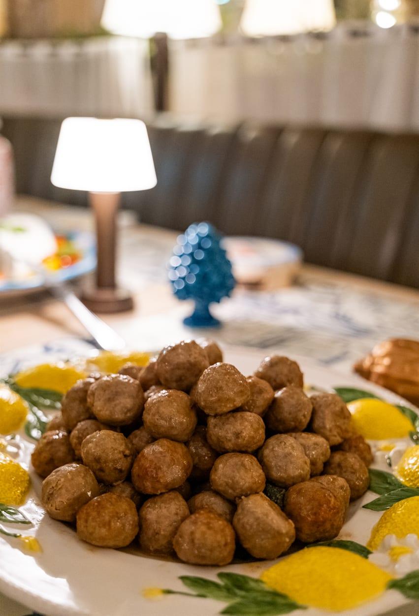 Polpette al sugo on a lemon-painted platter, at Jou Jou Brasserie